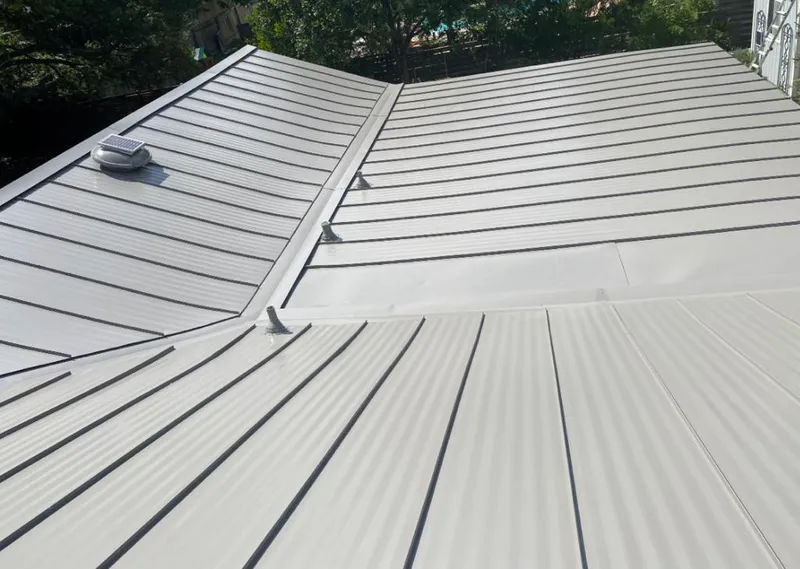 Solar attic fan installed on a metal roof for Roof Ventilation in Geneva